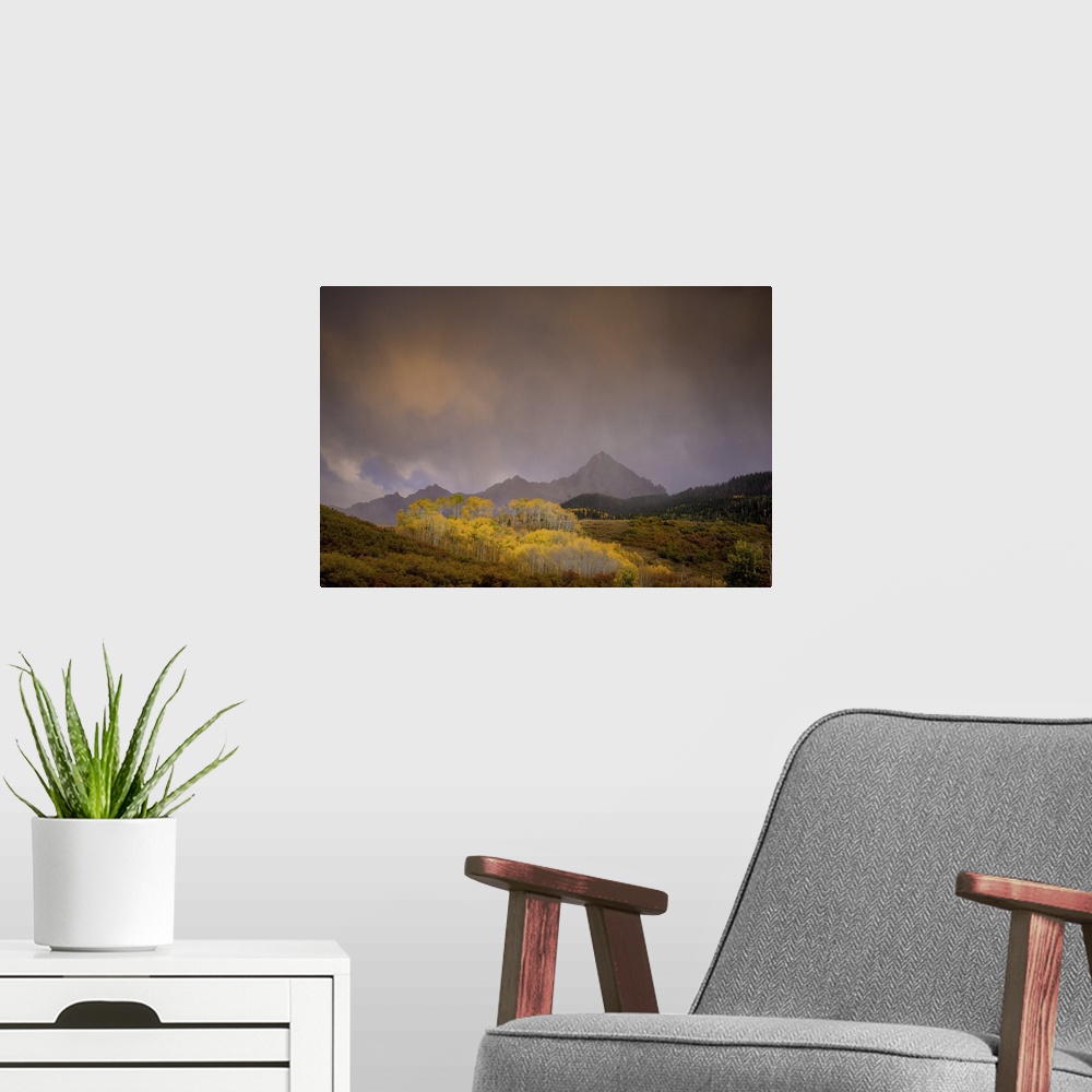 A modern room featuring A photograph of a mountain landscape with hazy clouds hanging overhead.