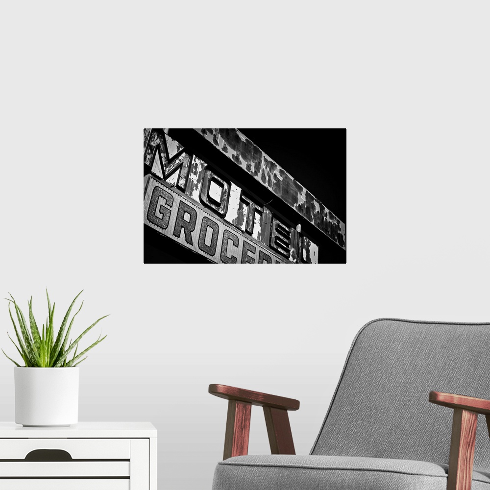 A modern room featuring Black and white photograph of a vintage motel sign.