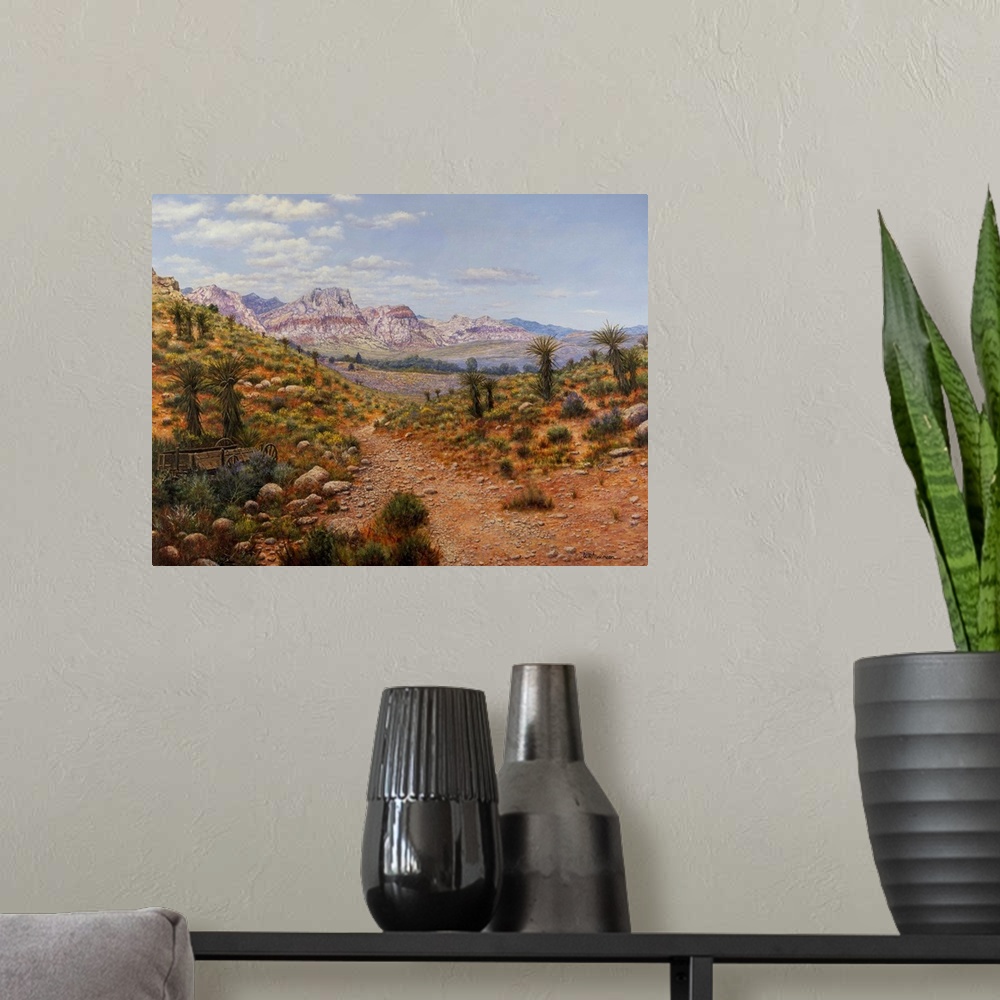 A modern room featuring Dirt trail through arid land with canyons and water in distance.