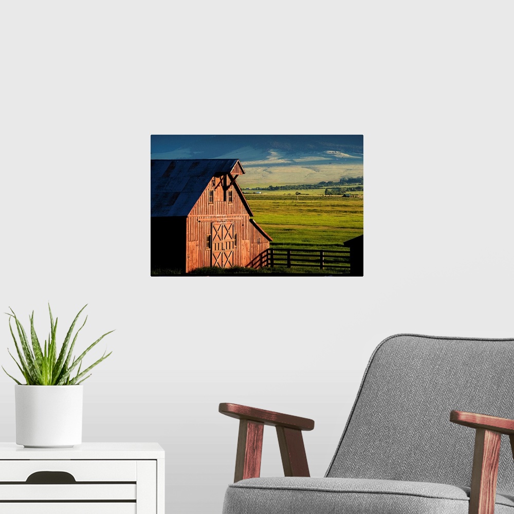 A modern room featuring Photograph of a red barn with green farmland in the background.