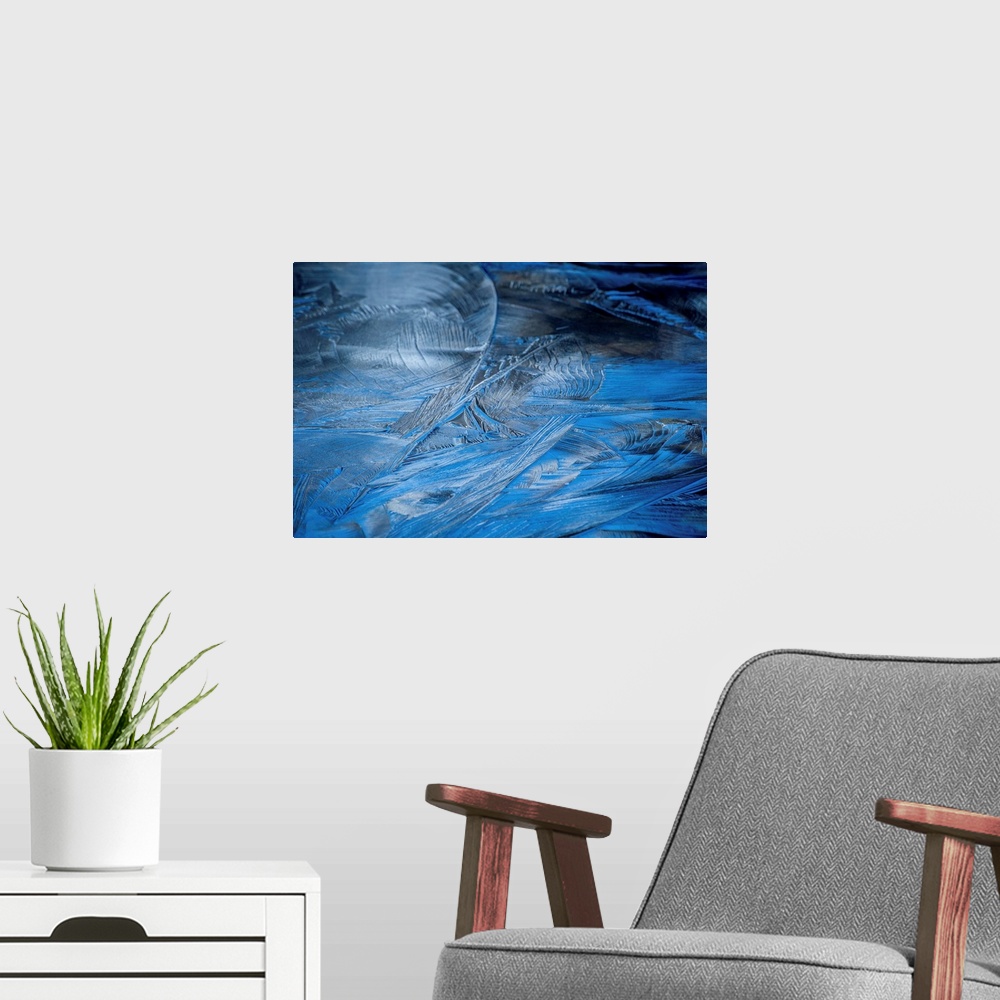 A modern room featuring Close-up abstract photograph of the texture from frozen water in shades of blue.