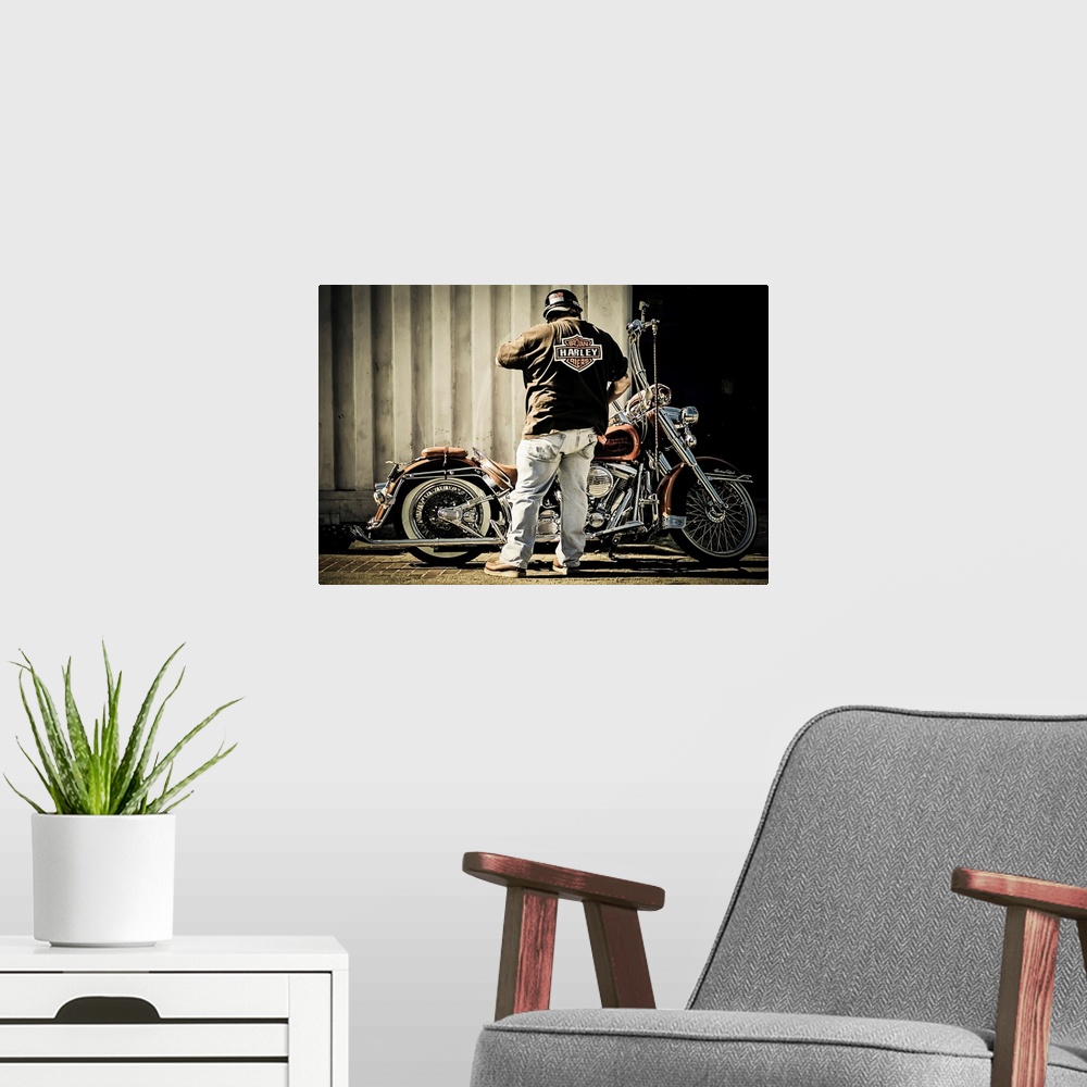 A modern room featuring Biker with his motorcycle
