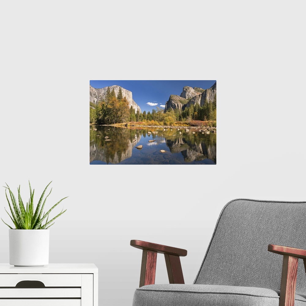 A modern room featuring El Capitan and Bridalveil Falls in Yosemite reflected in the clear water of the River Merced.