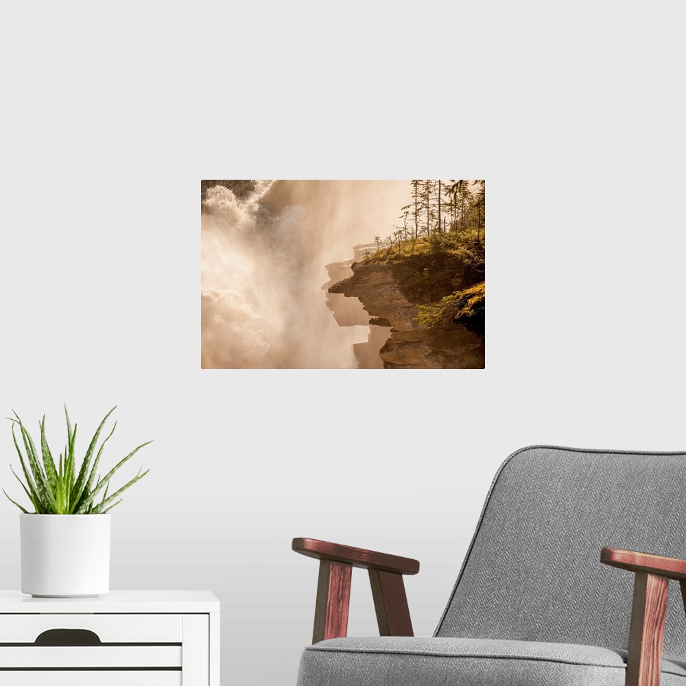 A modern room featuring Misty photograph of rocky cliffs next to a large, rushing waterfall.