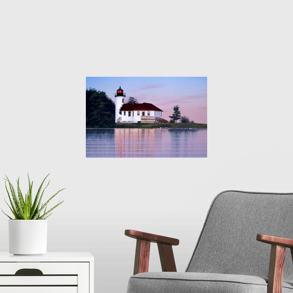 A modern room featuring A white lighthouse and house at sunset (or sunrise).