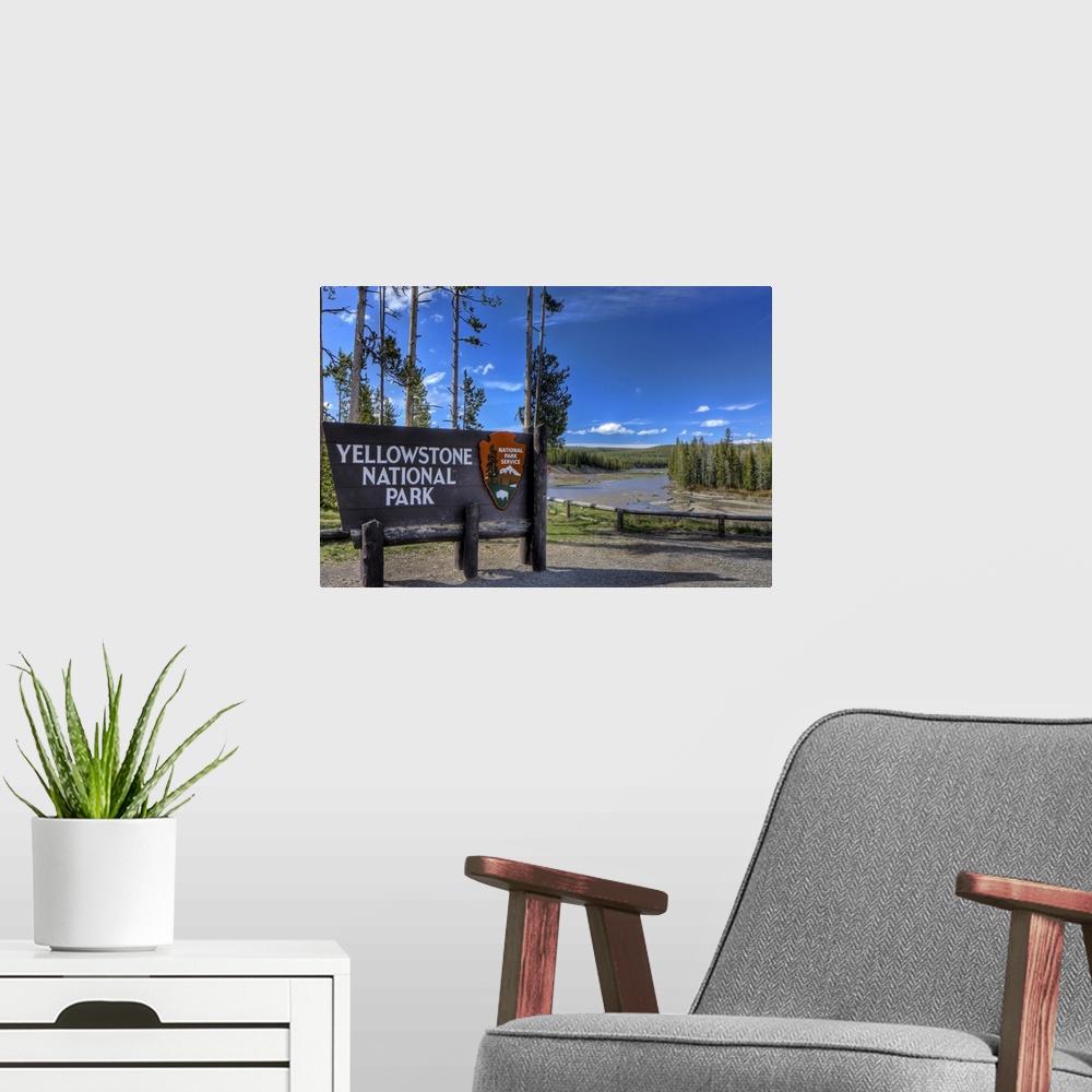 A modern room featuring A photograph of the Yellowstone National  Park sign in Wyoming.