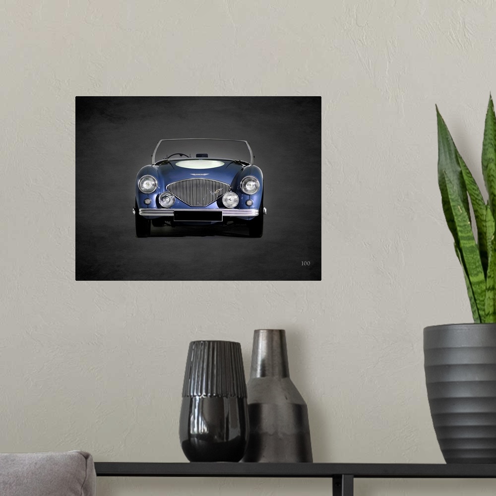 A modern room featuring Photograph of a blue 1953 Austin-Healey 100 printed on a black background with a dark vignette.