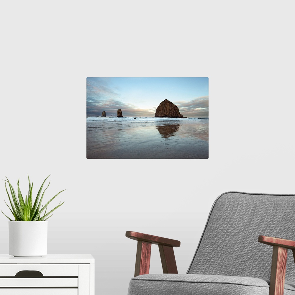A modern room featuring Photograph of large rocks along the coastline of a beach.
