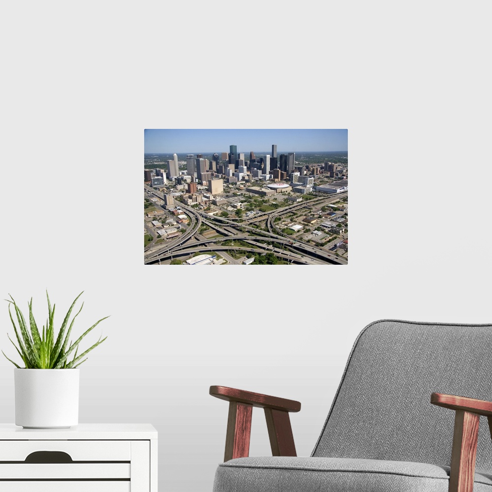 A modern room featuring Aerial view of the freeway interchange of Interstate 45 and U.S. Highway 59 in the city of Housto...