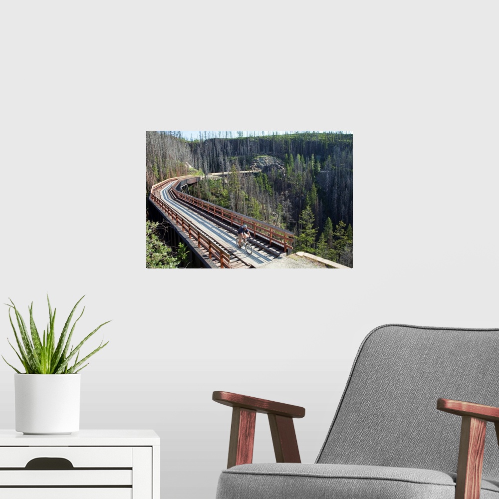 A modern room featuring Mike Deme rides across trestle in Myra Canyon on the Kettle Valley Railway bike path near Kelowna...