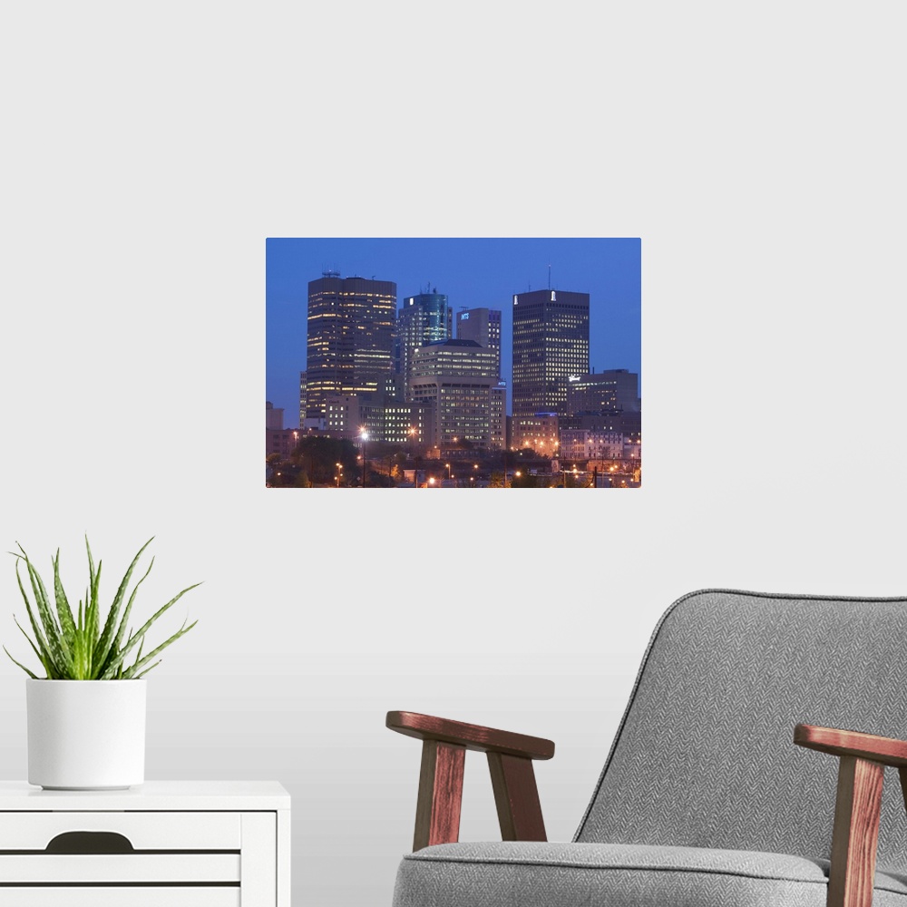 A modern room featuring CANADA-Manitoba-Winnipeg:.Downtown Highrises from The Forks Area- Dawn