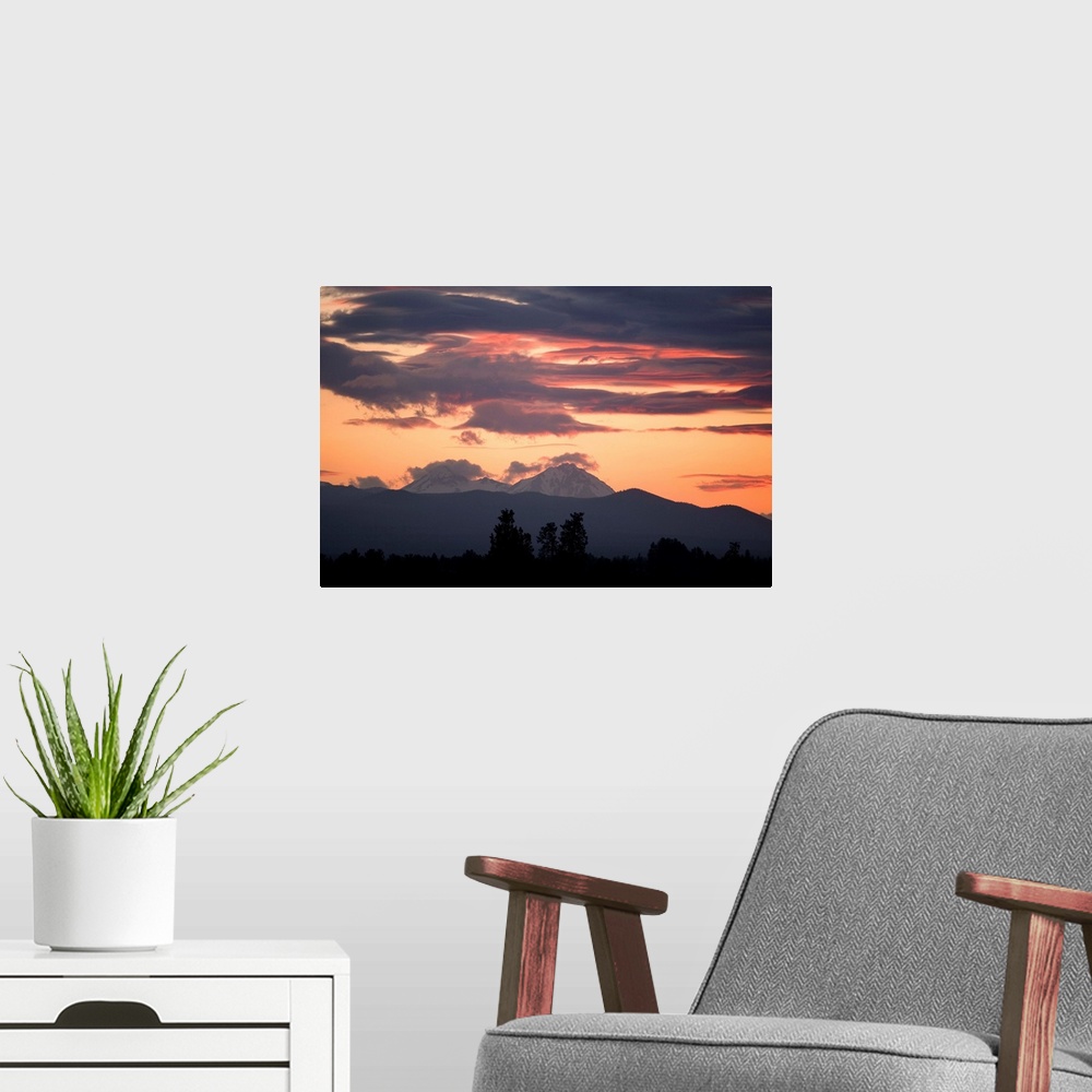 A modern room featuring USA, Oregon, Bend. Clouds gather around the Soth and Middle Sisters at sunset in Deschutes County...