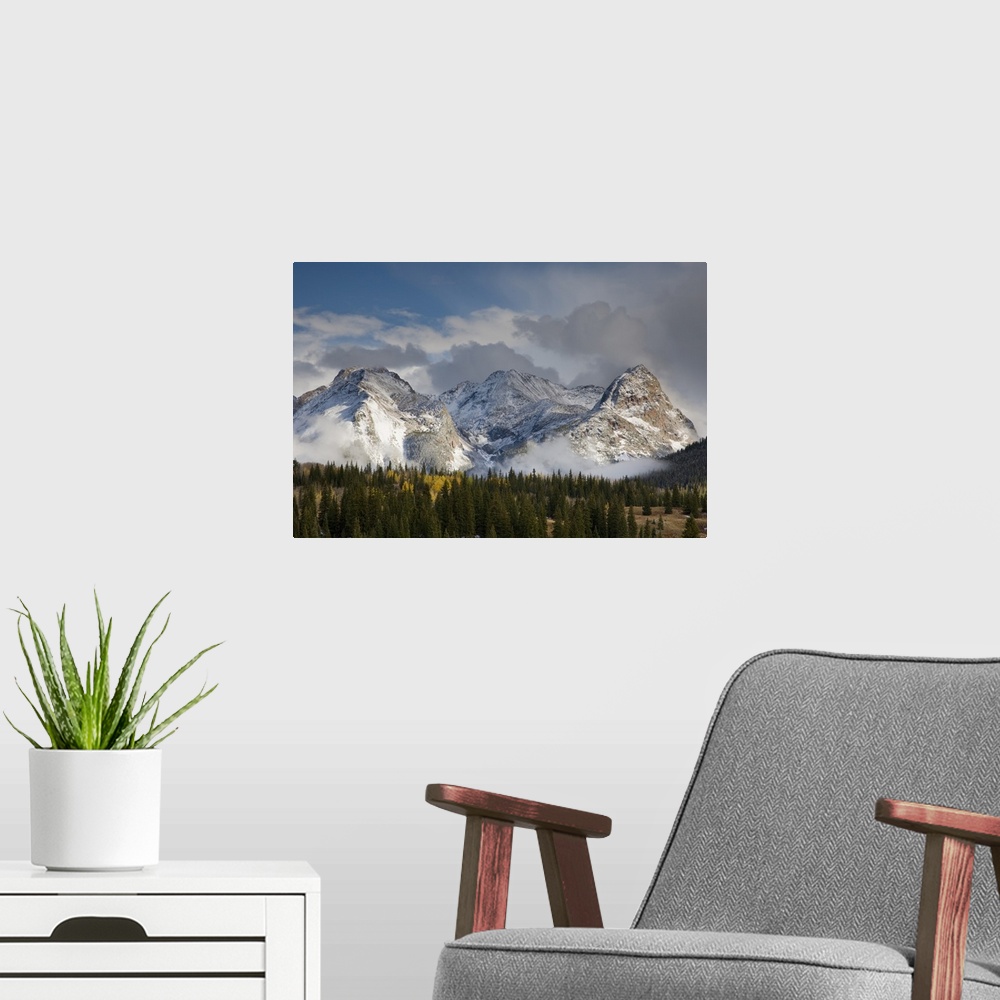A modern room featuring USA, Colorado, San Juan Mountains, Uncompahgre National Forest. Clouds swirl around the snow-cove...