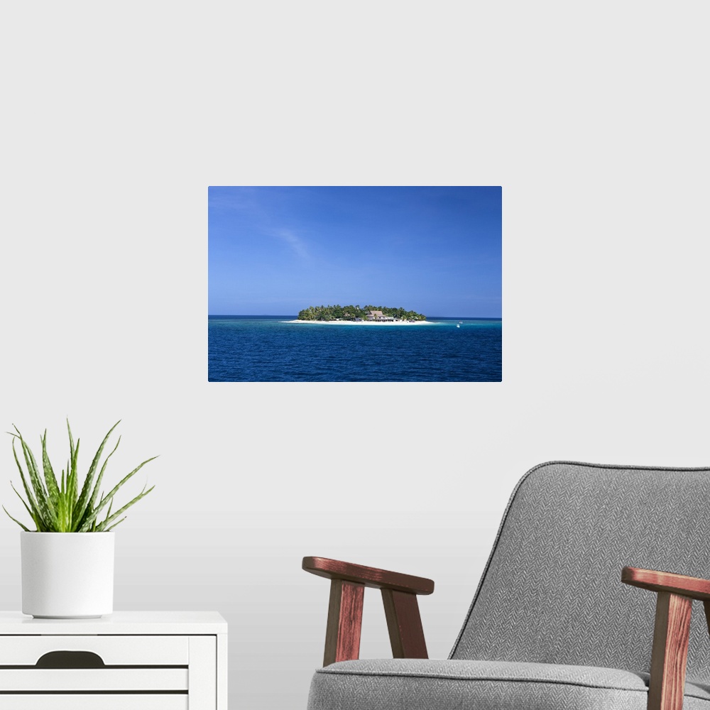 A modern room featuring Fiji. Boats head towards Beachcomber Island, in the Mamanuca Island chain. This island is known a...