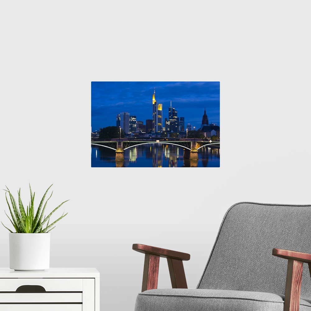 A modern room featuring GERMANY, Hessen, Frankfurt am Main. Skyline from Main River and Ignatz Bubis Brucke bridge, dawn.