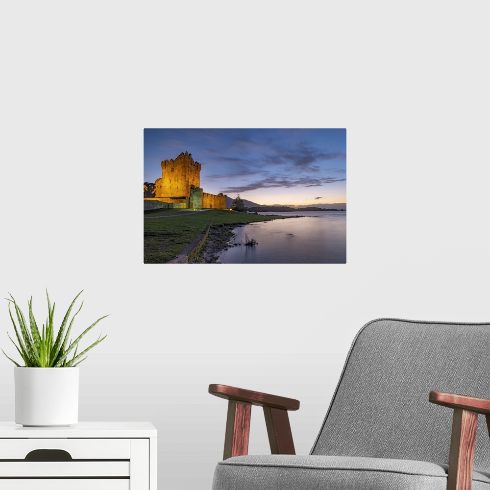 A modern room featuring Historic Ross Castle at dusk in Killarney National Park, Ireland.
