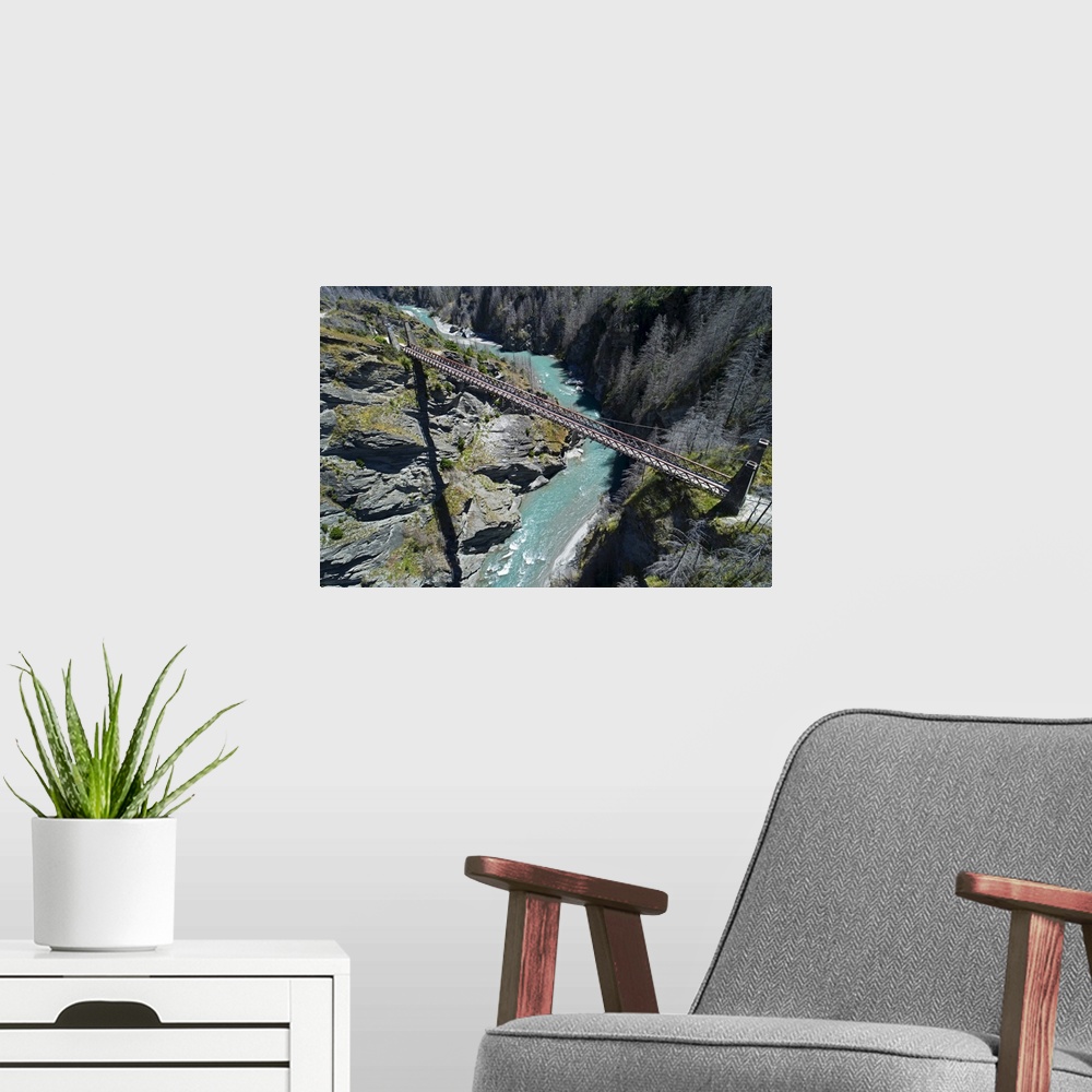 A modern room featuring Historic skippers suspension bridge (1901), above shotover river, skippers canyon, Queenstown, So...