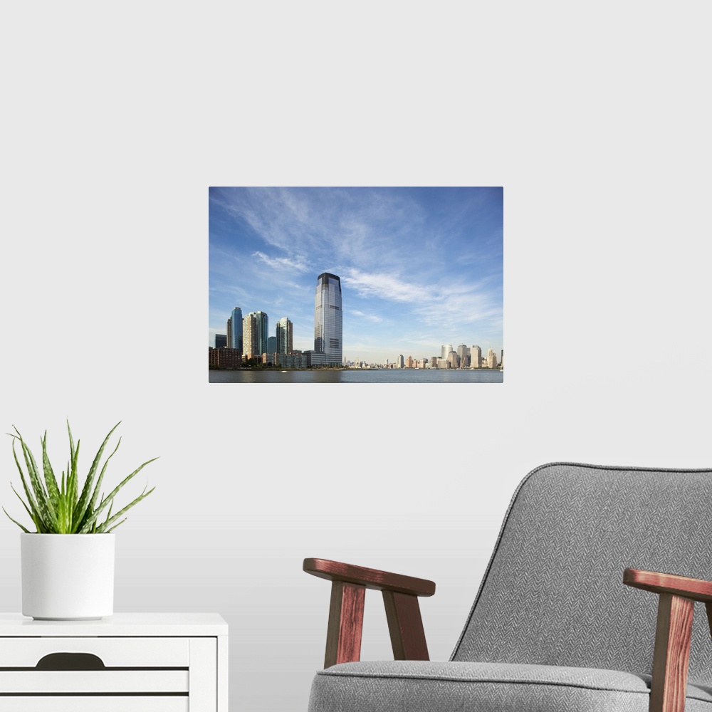 A modern room featuring USA, New Jersey, Jersey City, Manhattan skyline rises above Hudson River across from rising skysc...