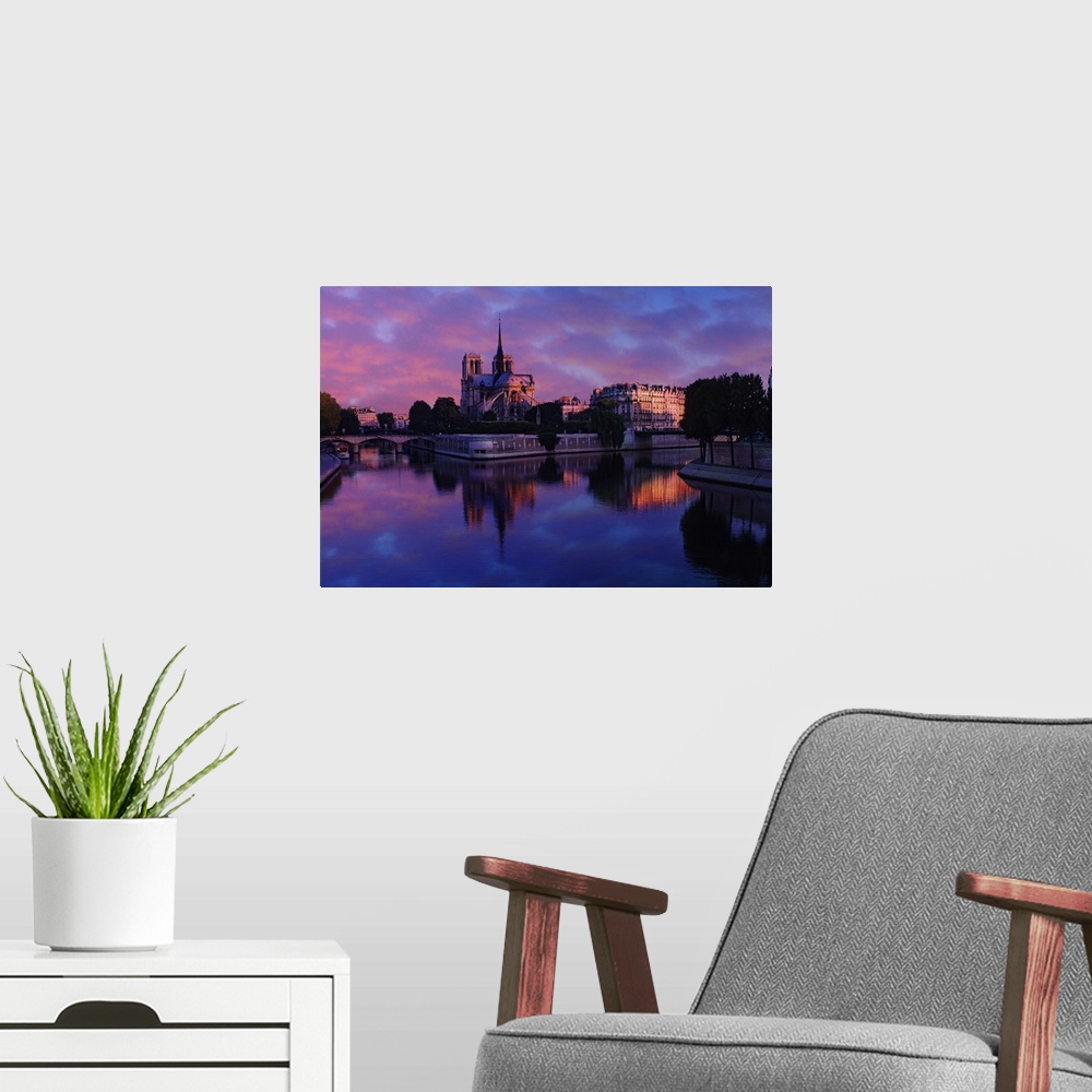 A modern room featuring Notre Dame reflected on Seine River at sunrise, Paris, France