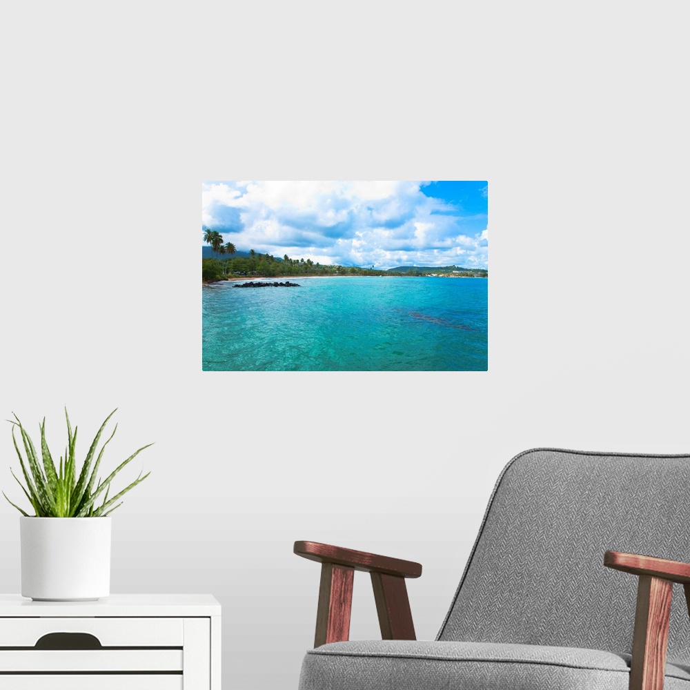 A modern room featuring San Juan, Puerto Rico - Calm water is seen in the bay of a tropic island. Trees and beach can be ...