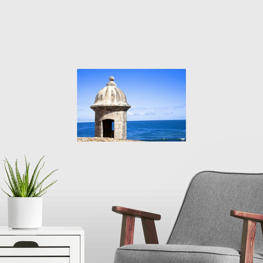 A modern room featuring San Juan, Puerto Rico - An old stone watchtower looks out over the ocean. Horizontal shot.