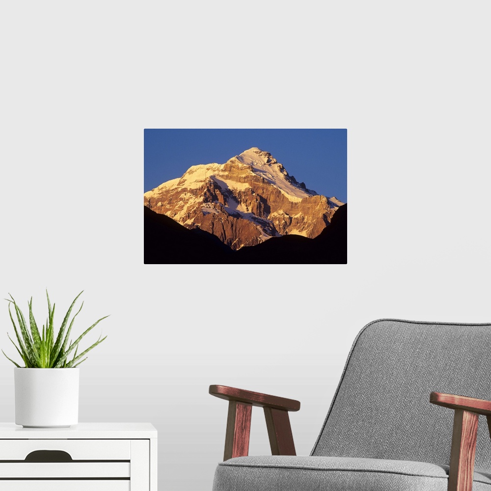 A modern room featuring Sunrise on east face of 22,841' Cerro Aconcagua, highest mountain in the Andes, viewed from the V...