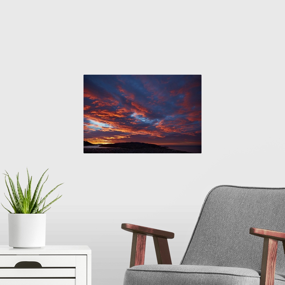 A modern room featuring Sunrise over Otago harbor and Pacific Ocean, Dunedin, South Island, New Zealand.