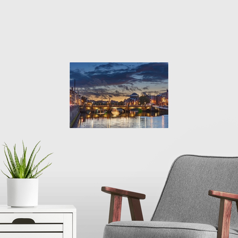 A modern room featuring The Grattan bridge over the river Liffey at dusk in downtown Dublin, Ireland.