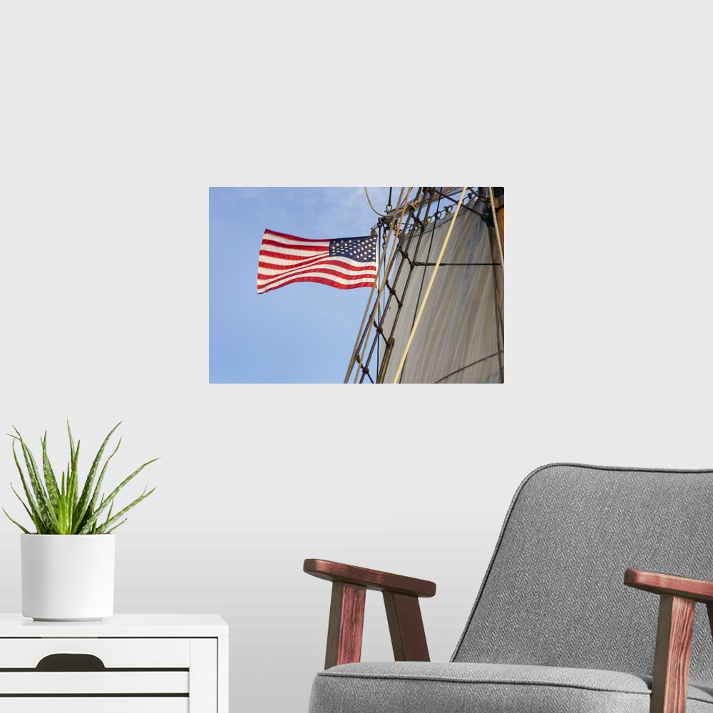 A modern room featuring United States flag flying on Hawaiian Chieftain, a Square Topsail Ketch. Owned and operated by th...