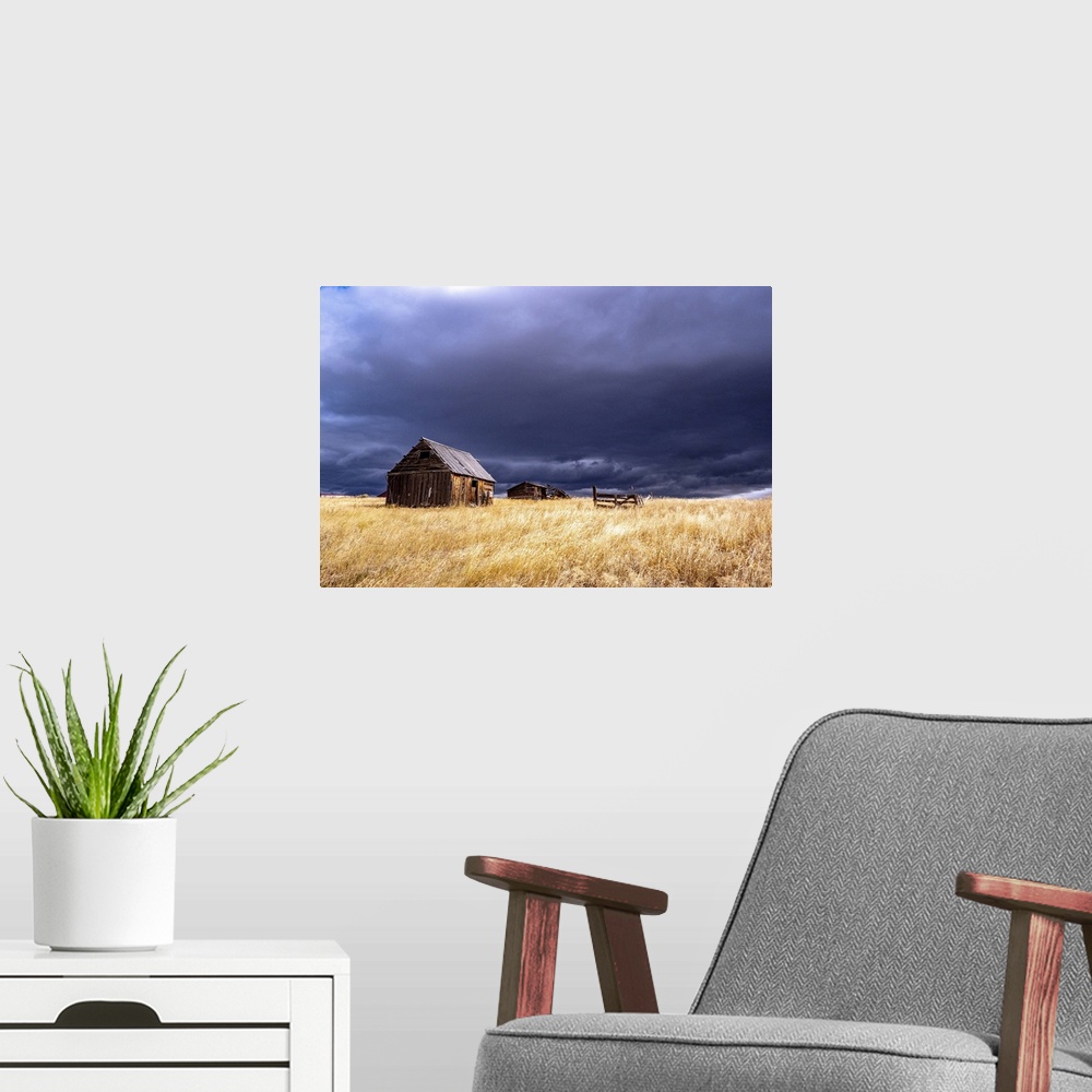 A modern room featuring USA, Idaho, Highway 36, Liberty storm passing over old wooden barn. United States, Idaho.