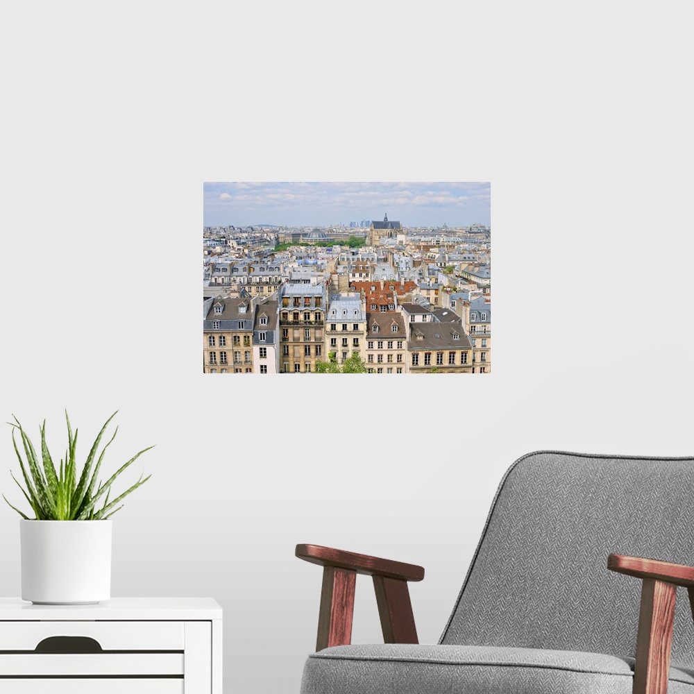 A modern room featuring Aerial panorama above houses rooftops in a Paris.