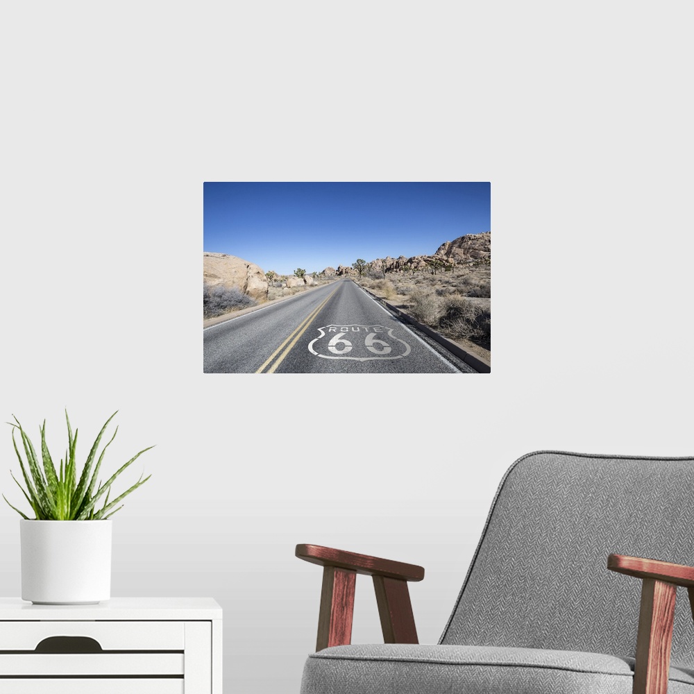 A modern room featuring Joshua tree highway with route 66 pavement sign in Californiaos Mojave desert.