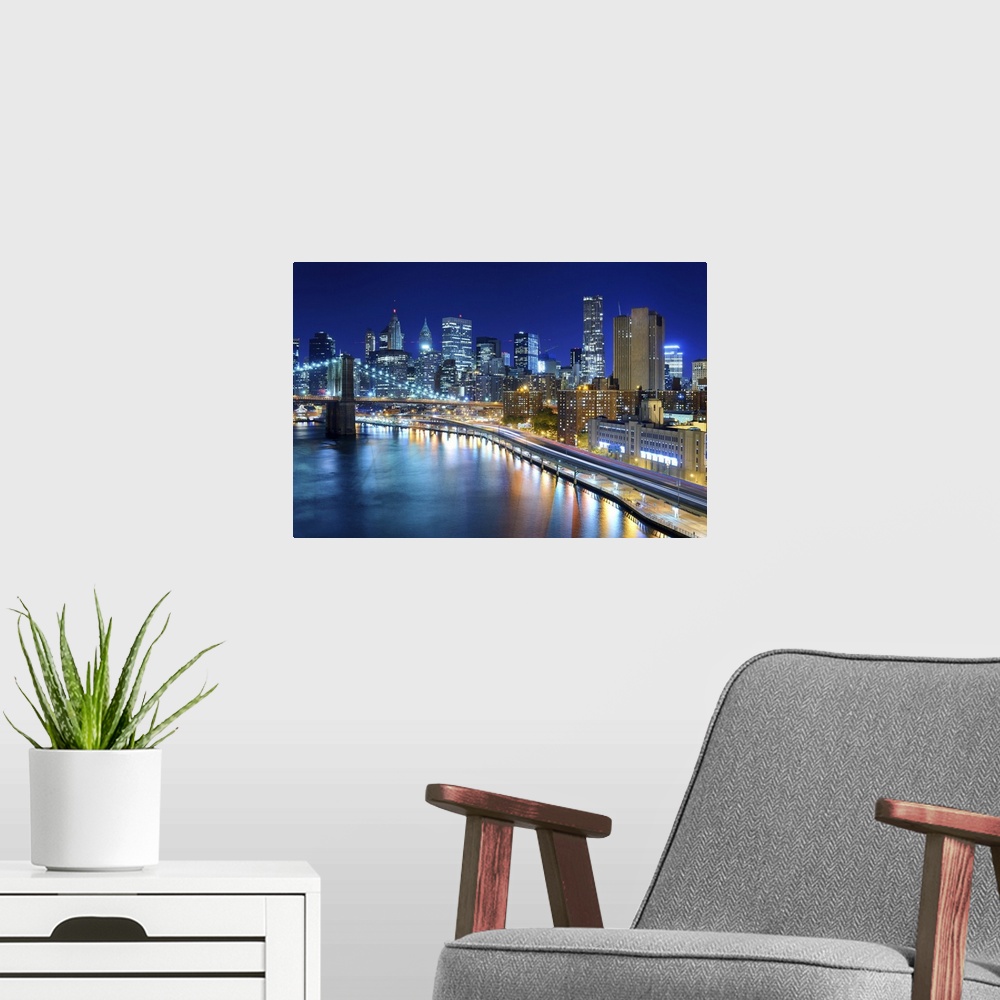 A modern room featuring View of the financial district of Manhattan at night in New York City.