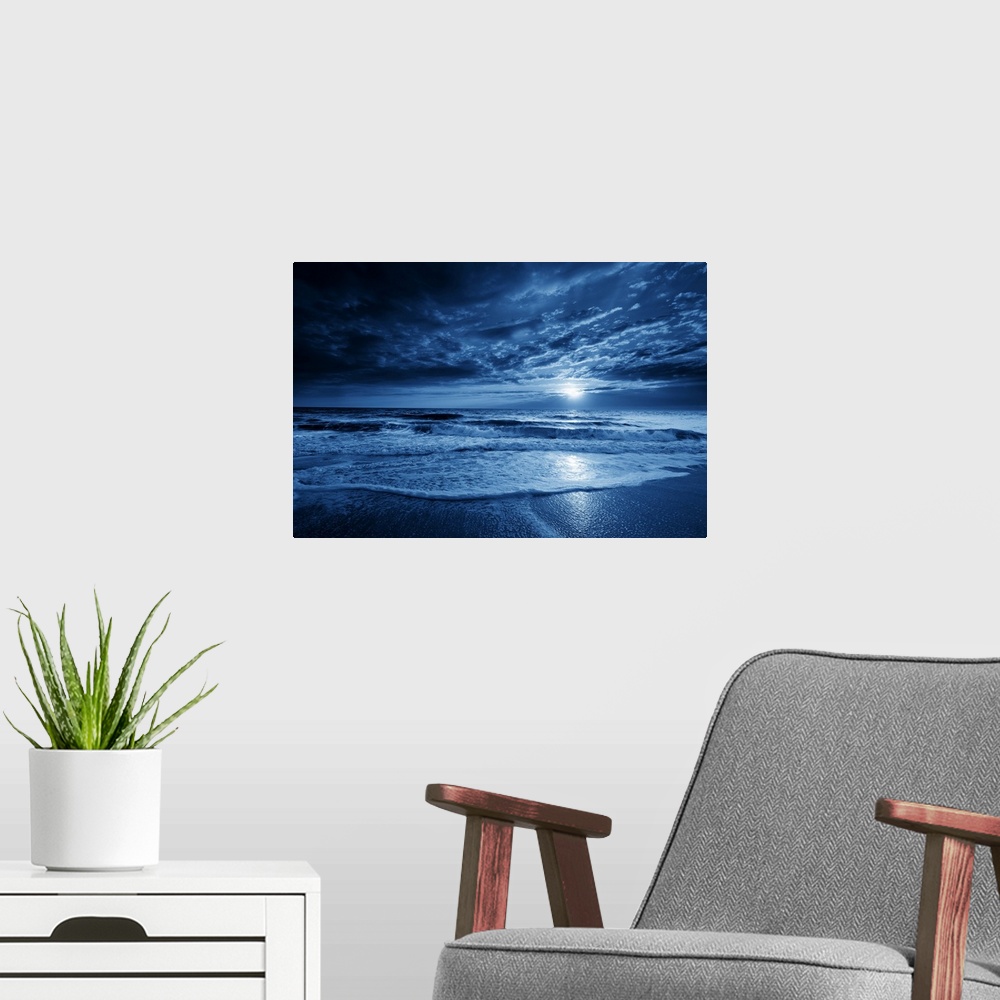 A modern room featuring This is a photographic illustration of a beautiful midnight-blue ocean moonrise with dramatic sky...