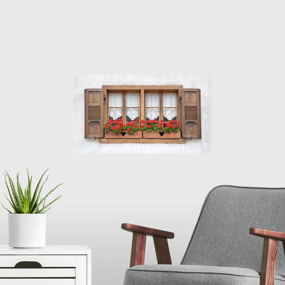 A modern room featuring Old European wooden windows with shutters and flowers.