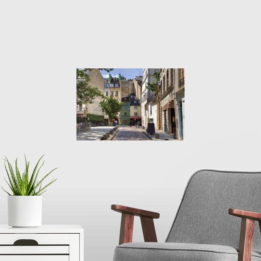 A modern room featuring View of narrow cobbled street among traditional Parisian buildings in Paris, France.