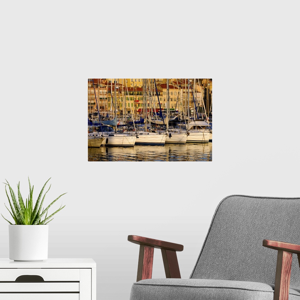 A modern room featuring The Vieux Port (old port) in the city of Cannes in the French riviera as the first rays of the mo...