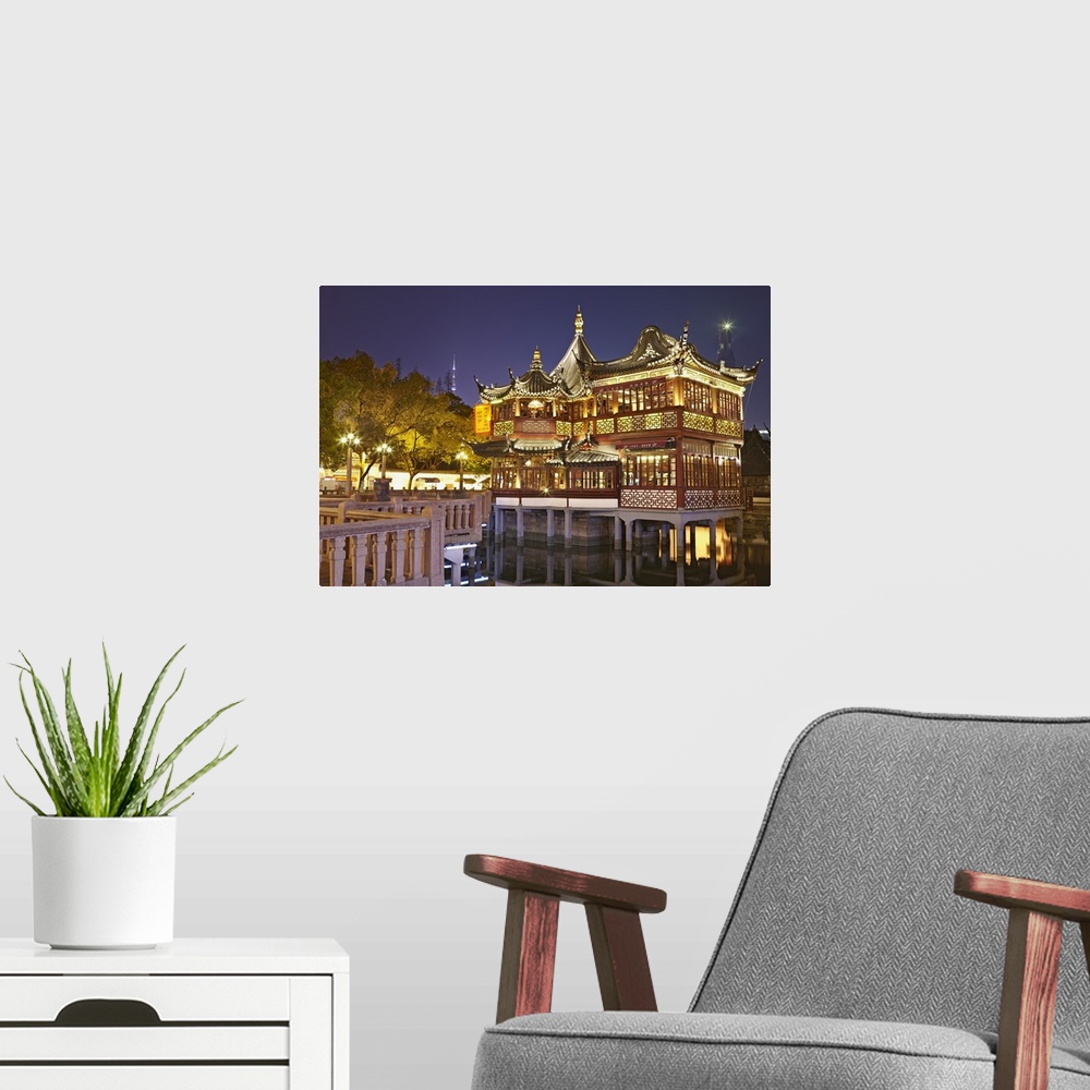 A modern room featuring China, Shanghai, Huxinting Teahouse illuminated at night, Yuyuan Gardens.
