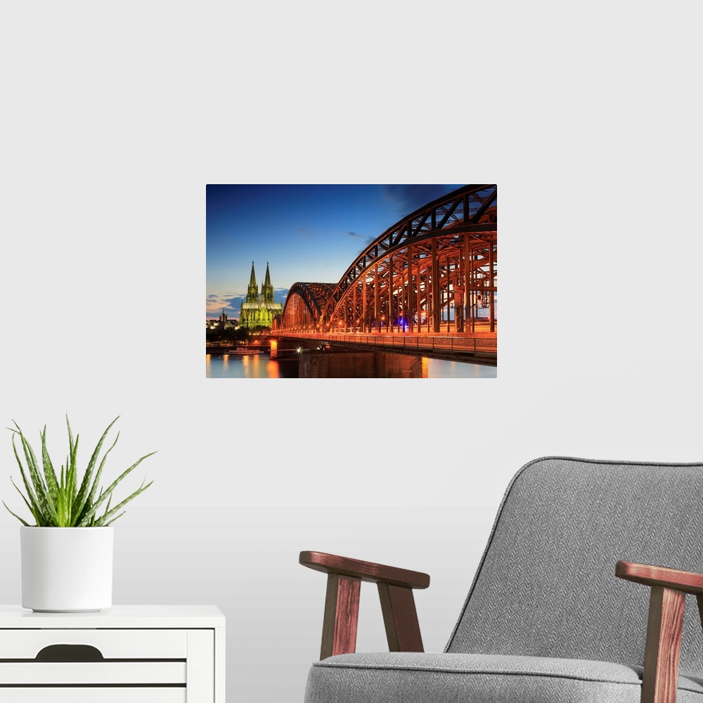 A modern room featuring Germany, North Rhine-Westphalia, Cologne, Cologne Cathedral and Hohenzollern Bridge in the evening.
