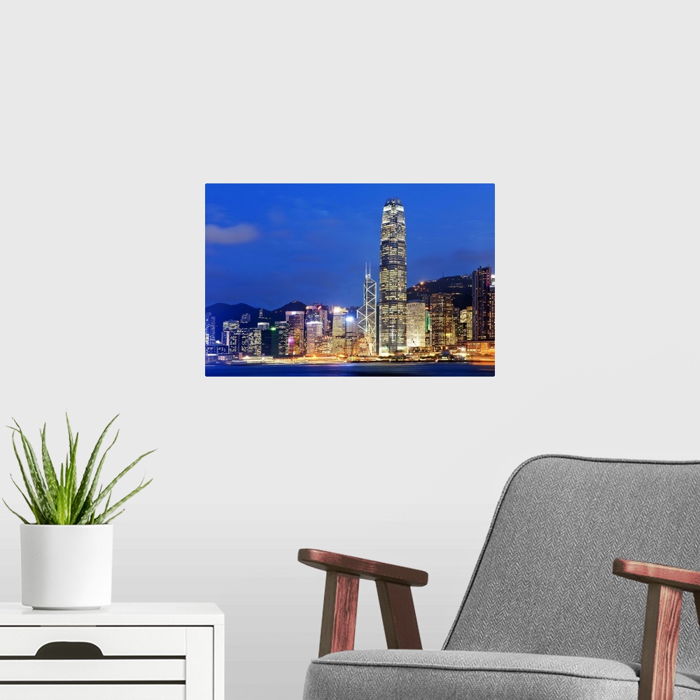 A modern room featuring China, Hong Kong, Hong Kong island, City skyline illuminated at night with International Finance ...