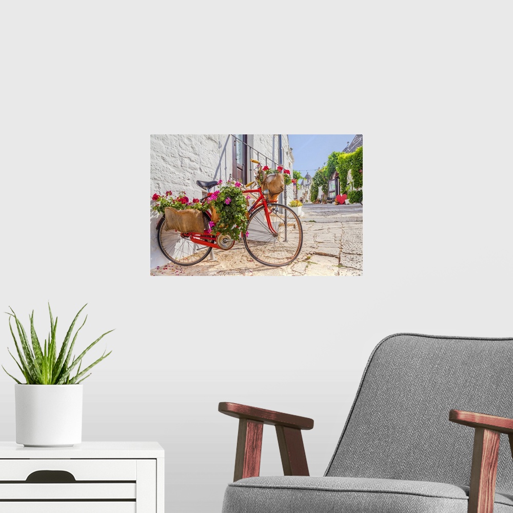 A modern room featuring Italy, Apulia, Bari district, Itria Valley, Alberobello, Bicycle in a typical street of Alberobello.