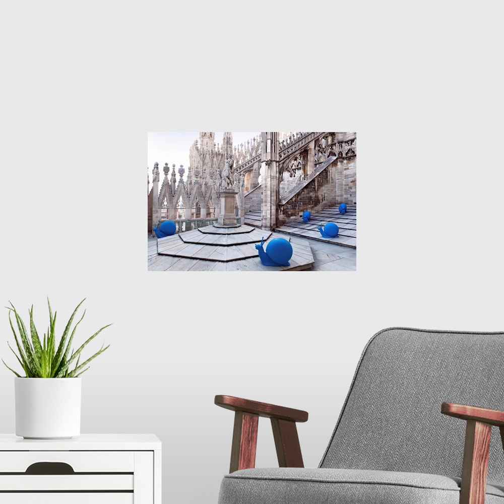 A modern room featuring Italy, Milan, Milan Cathedral, Blue plastic-made snails spread among the Cathedrals spires to gat...