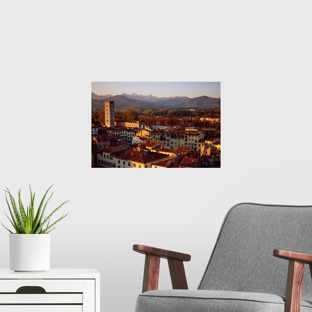 A modern room featuring Italy, Tuscany, Lucca, View across the city at sunset