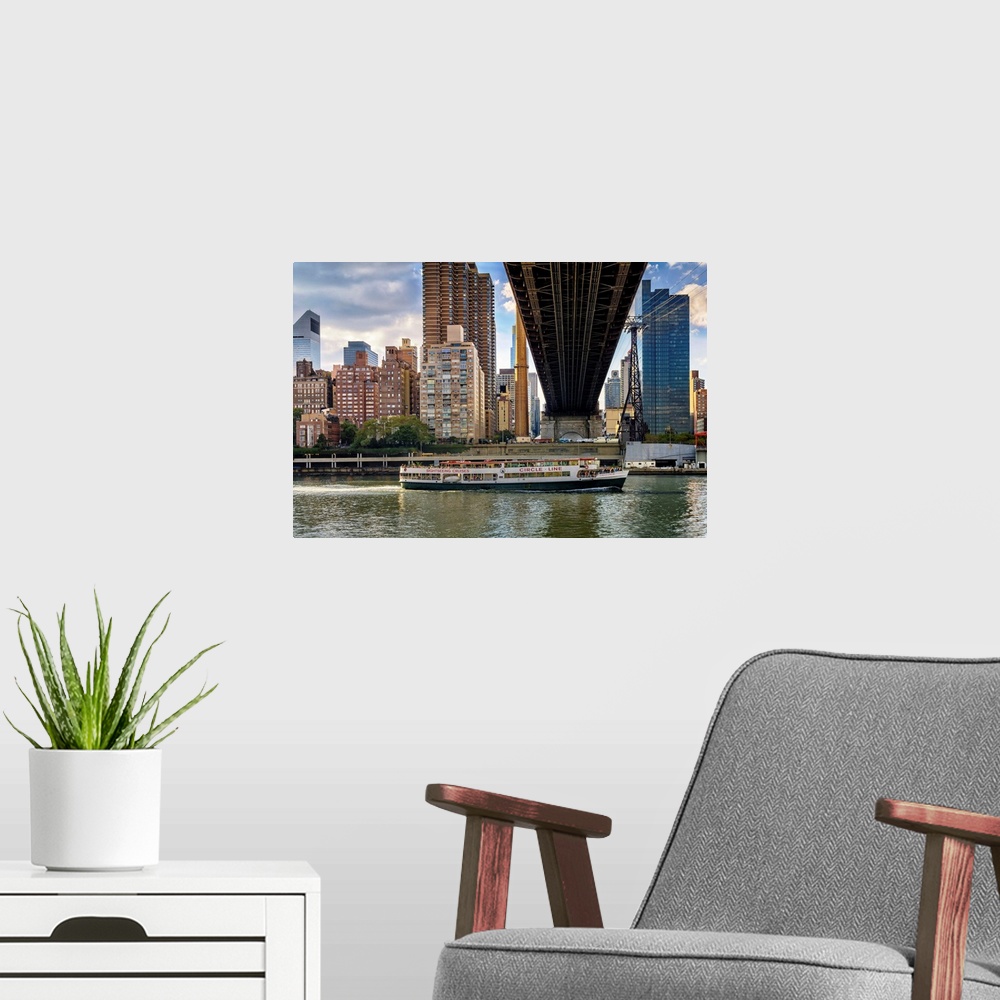 A modern room featuring New York, NYC, City skyline, Queensboro Bridge, cruise ship, viewed from Roosevelt Island.