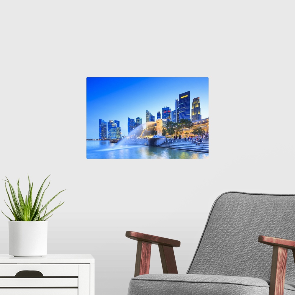 A modern room featuring Singapore, Singapore City, Merlion fountain at night.
