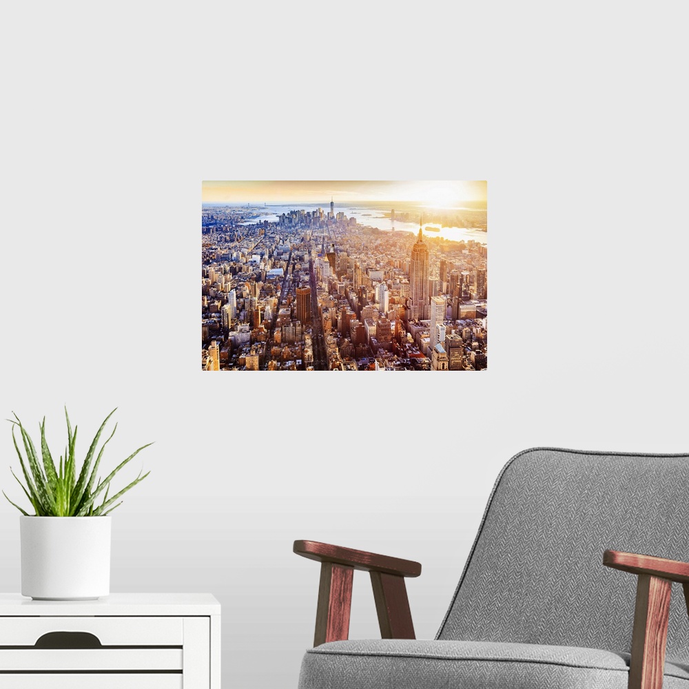A modern room featuring USA, New York City, Aerial view towards One World Trade Center and Hudson river at sunset.