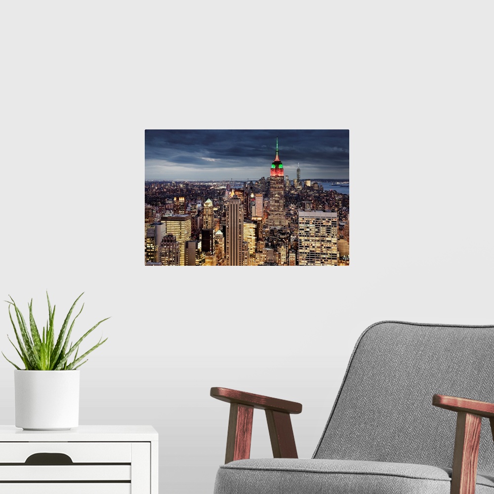 A modern room featuring USA, New York City, Midtown skyline and Empire State building from the Rockefeller Center Top of ...