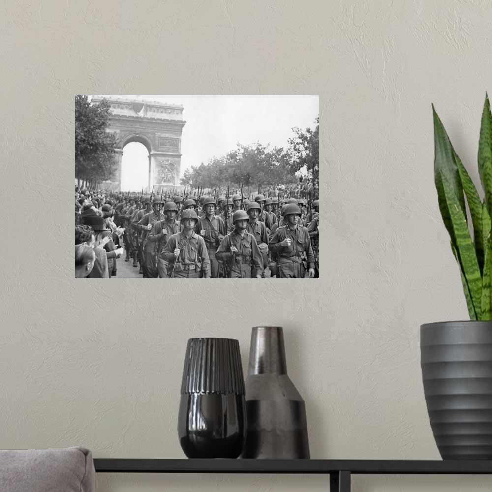 A modern room featuring American troops marched down the Champs Elysees to the cheers of Parisians. August 25, 1944, Worl...