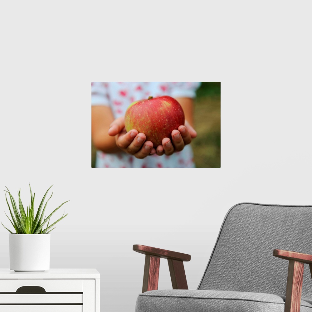 A modern room featuring Girl Holding Red Apple