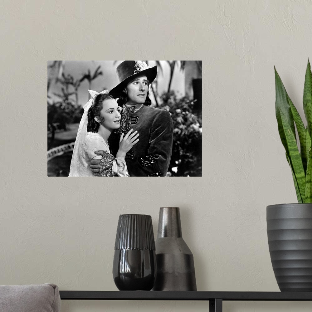 A modern room featuring Olivia de Havilland and Errol Flynn in Captain Blood - Movie Still